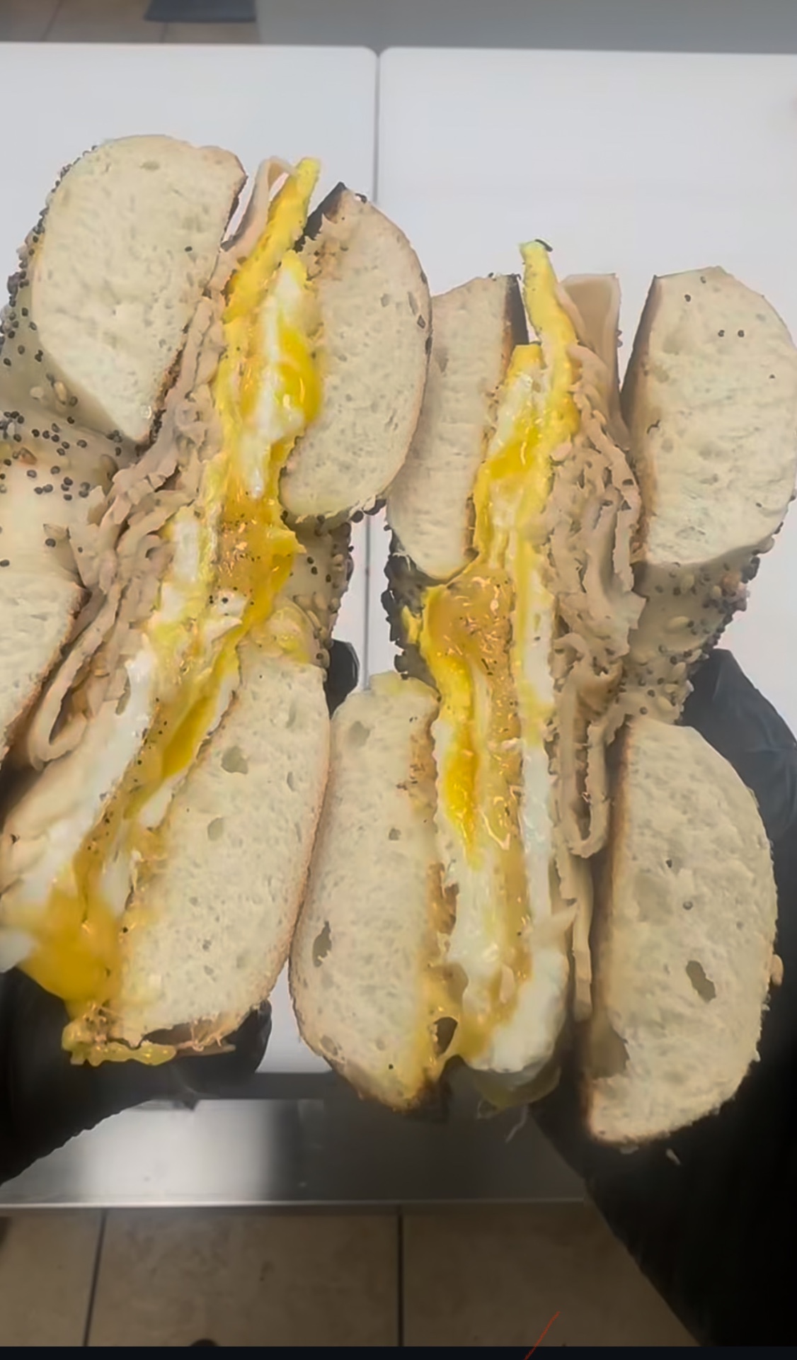 Turkey, egg and cheese on everything bagels — yolk dripping
