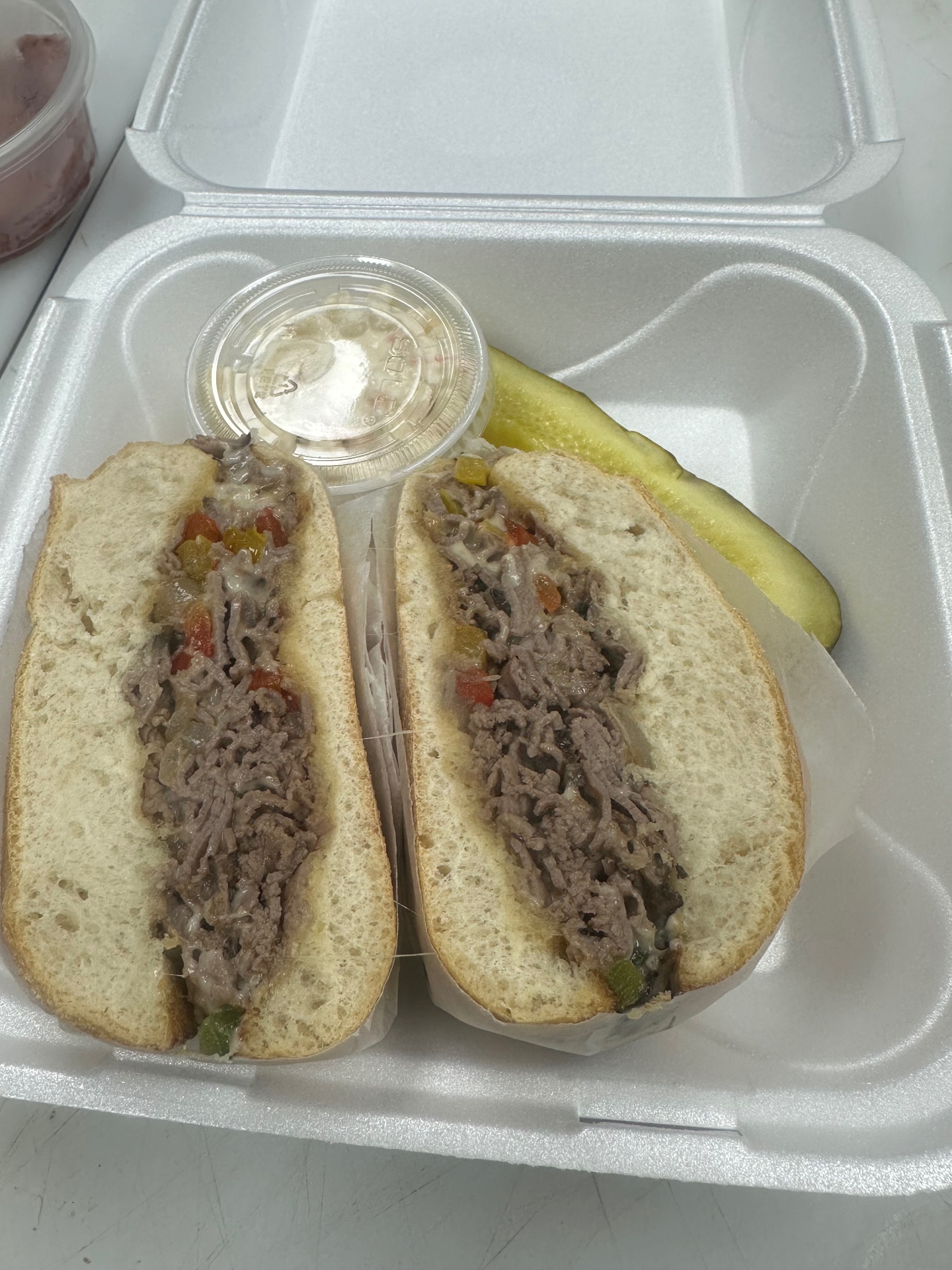 Philly cheesesteak sub with peppers, onions and melted cheese